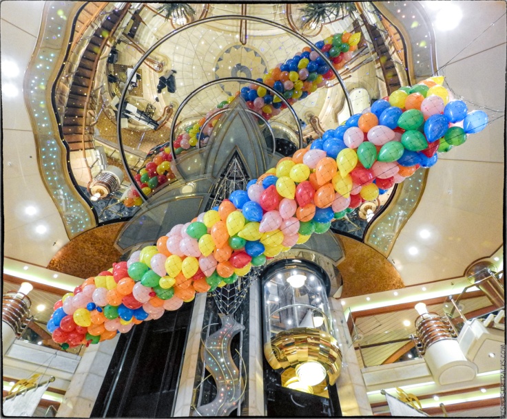 Balloons hanging from ceiling of cruise ship main atrium